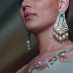 Portrait of a woman in traditional attire adorned with elegant jewelry, showcasing fashion and style.